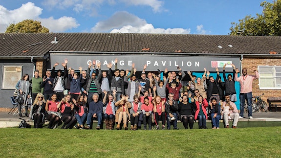 Large group of community members cheering outside Grangetown Pavillion