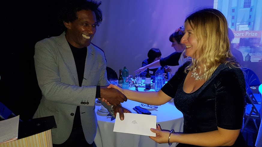 Poet Claire Williamson receives her prize from judge Lemm Sissay