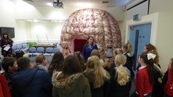 Dr Emma Kidd introducing school children to the Brain Games Dome