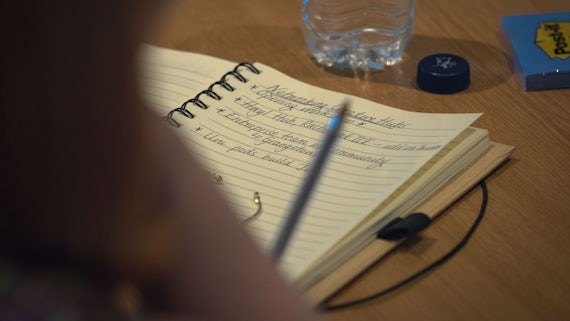Close-up of a notebook and water bottle