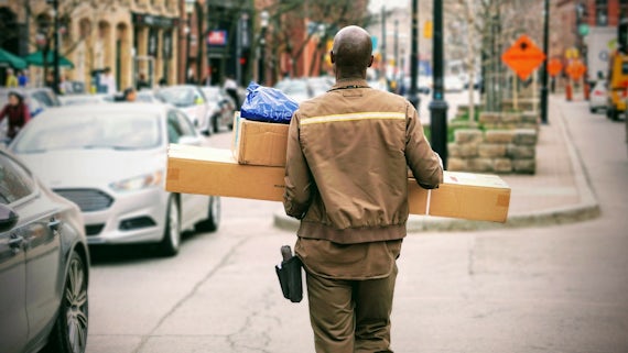 Man carrying parcels on street