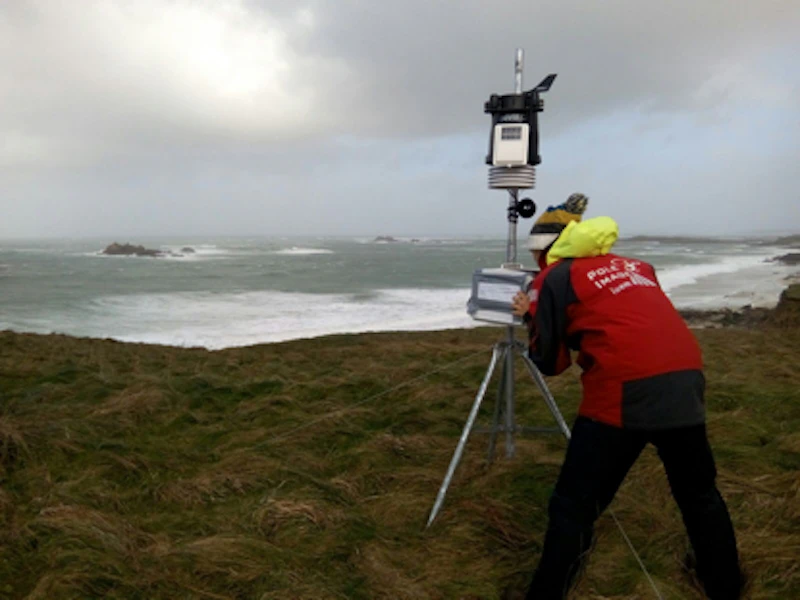 Researcher measuring changes in sea cliffs