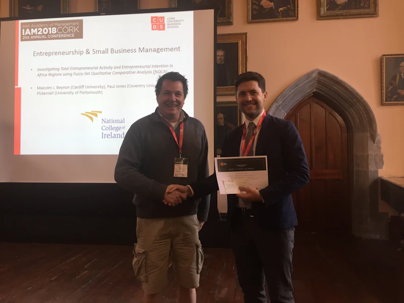 Man receiving award in decorative room