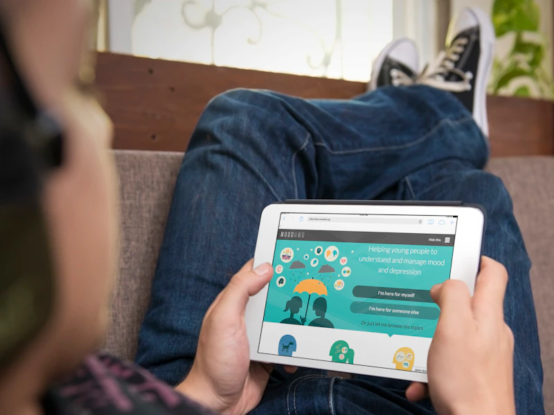 Photograph of adolescent boy accessing MoodHwb on a tablet
