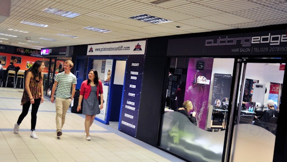 Three students walking through the hallways of the Students' Union.