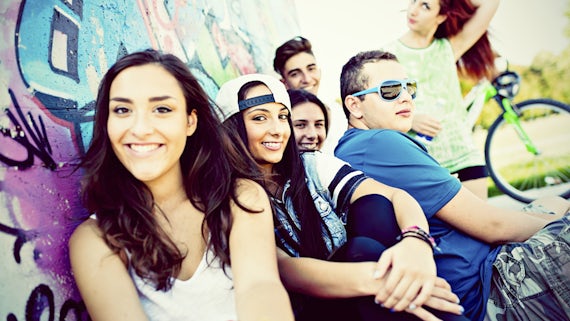  teenagers infront of graffiti wall 