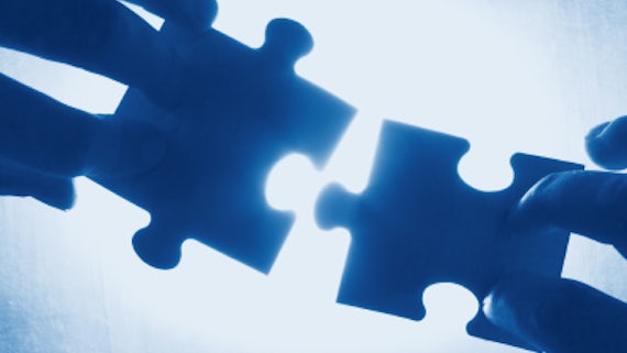 Stock image of puzzle pieces being put back together