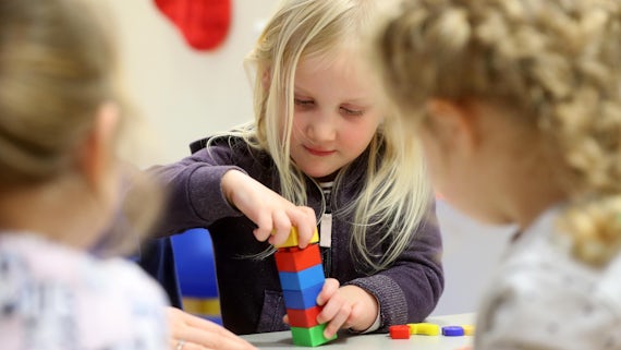 Girl playing with building blocks 