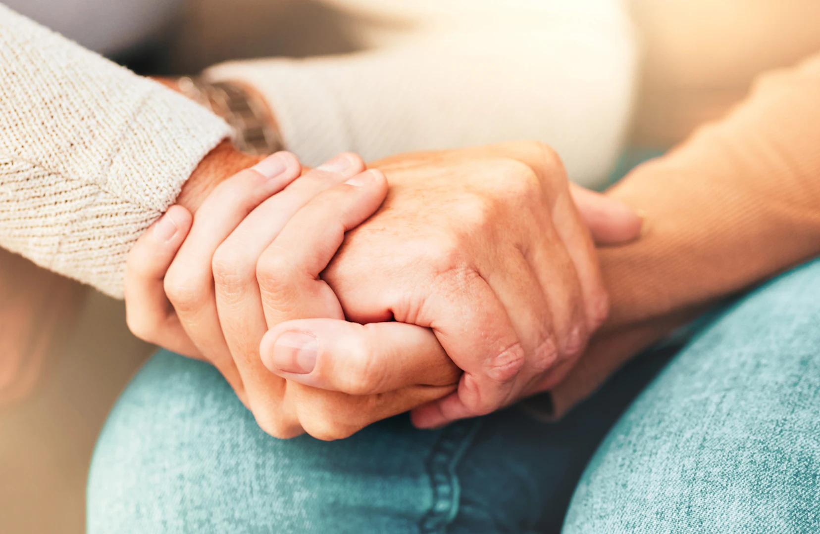 Two people holding hands