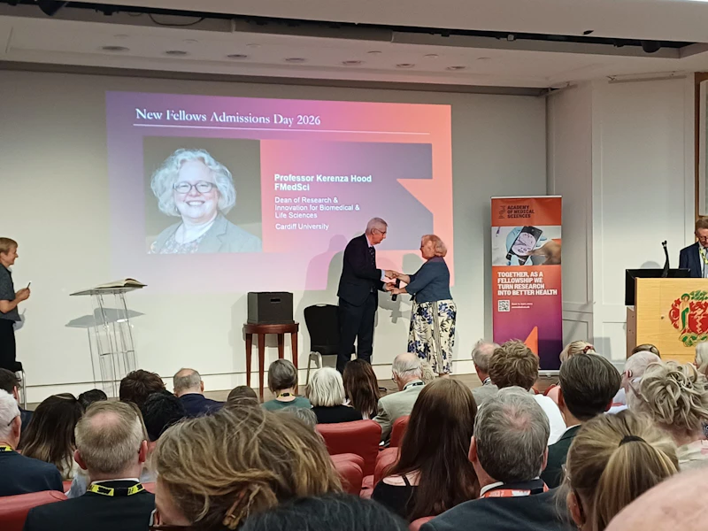Professor Kerenza Hood on stage collecting her award of Fellow of Academy of Medical Sciences