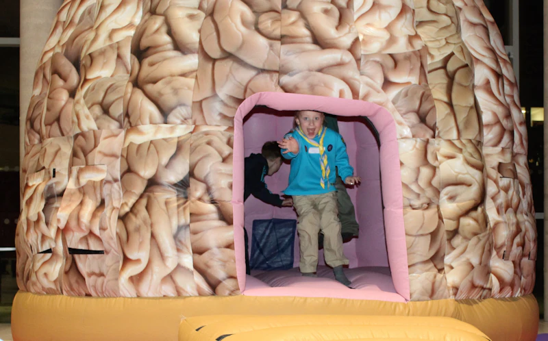 Photograph of child in giant brain dome