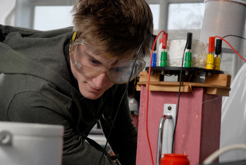 Male student working with a large battery