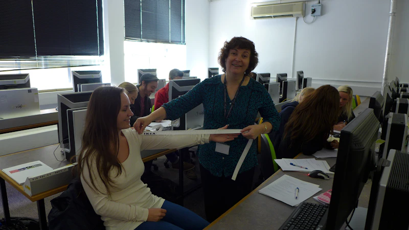 A speaker measures the arm of a college student attend a session on data analysis and interpretation at the ESRC conference. 