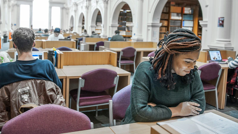 Two students studying back to back in the Science Library