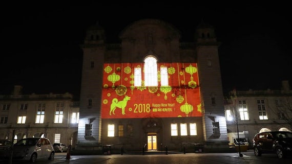 Cardiff University Main Building lit up with a Chinese New Year greeting