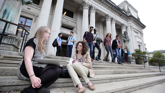 Postgraduate students sitting on the steps