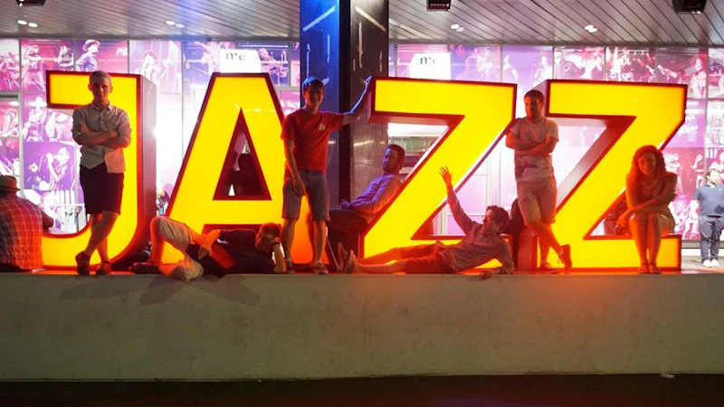 Lit up Jazz sign with performers