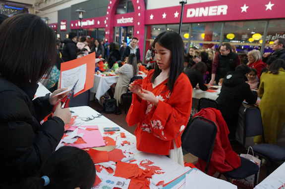 A Chinese tutor demonstrates paper cutting