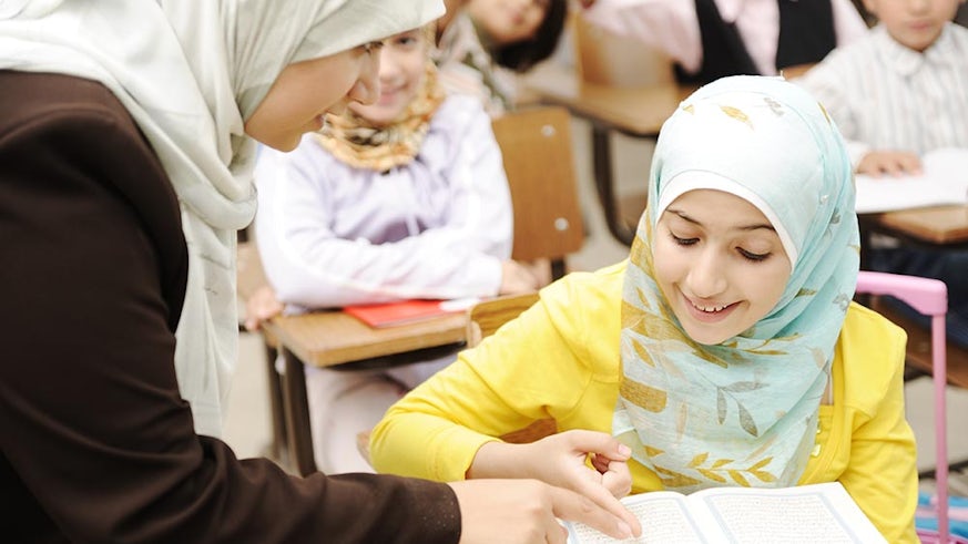 Muslim teacher with pupils