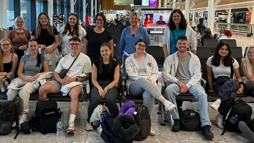 Optometry staff and students travelling to Malawi in an airport - all standing together
