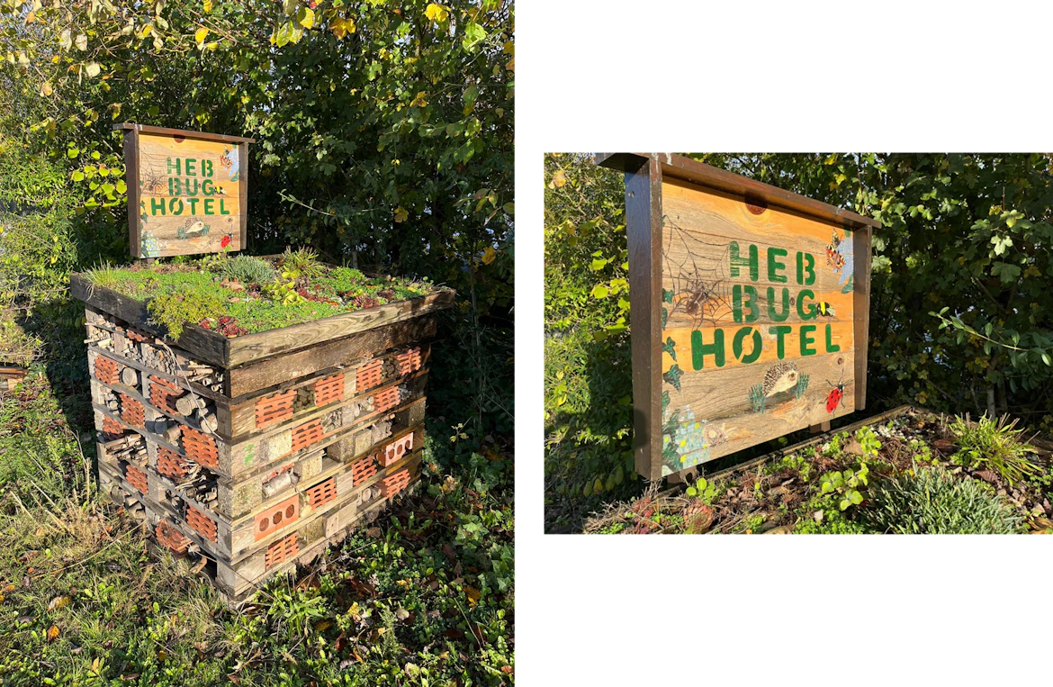A bug hotel constructed from bricks and wood