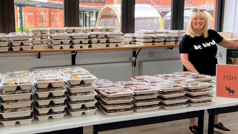 A lady next to lots of lunches