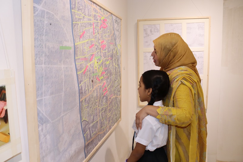 Girl and adult look at exhibit.