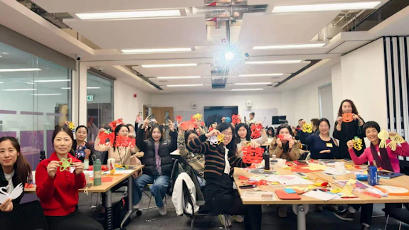 Chinese tutors showing their paper-cutting artwork