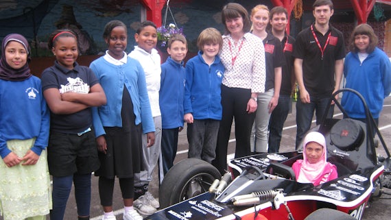 Primary school children with the Cardiff Racing car