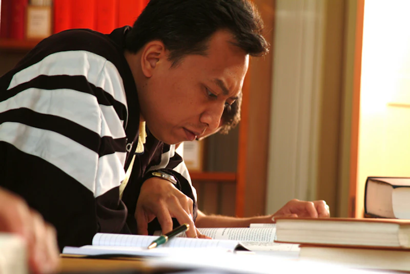 Man closely reading a document.