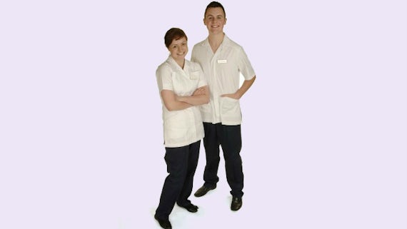 Male and female students modelling radiotherapy uniform for School of Healthcare Sciences