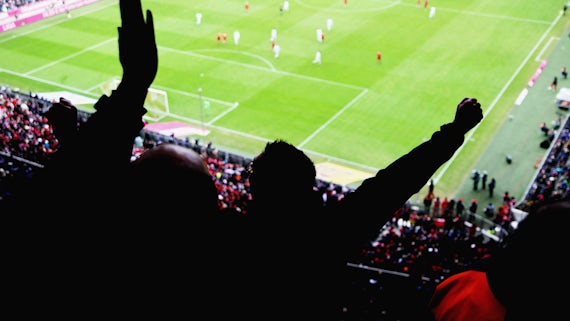Fans cheering in football stadium