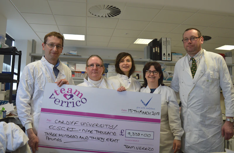 Team Verrico presenting donation in Institute lab