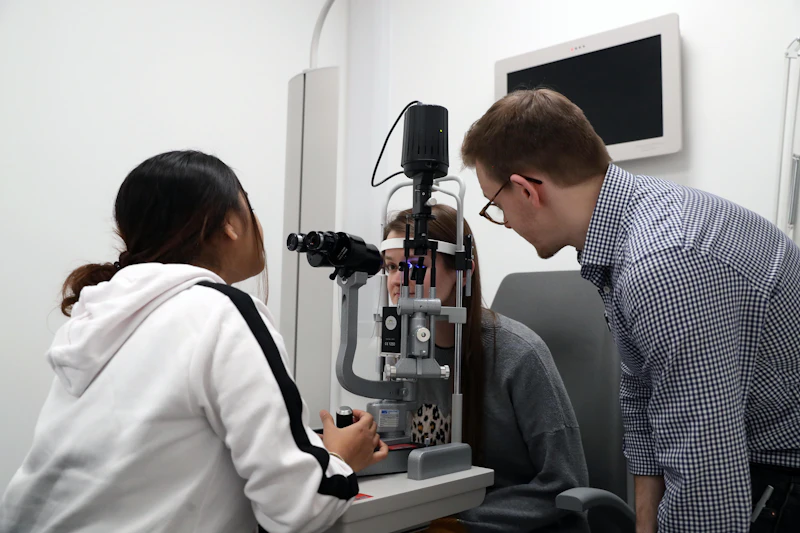 A postgraduate student conducting an eye examination