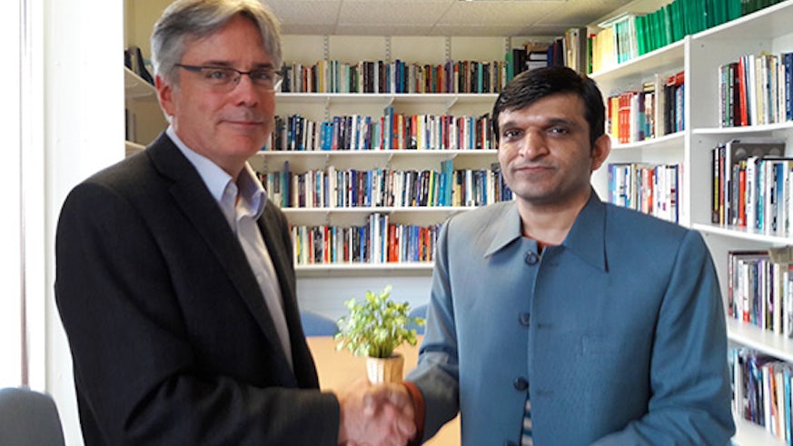 Professor Stuart Allan signs the new agreement with Associate Professor Dr Shahzad Ali of Bahauddin Zakariya University, Pakistan.