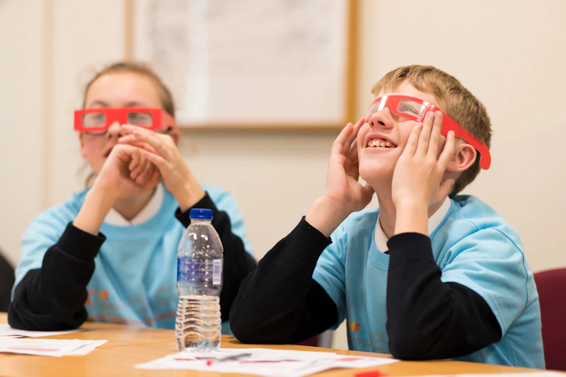 Two young students in red glasses