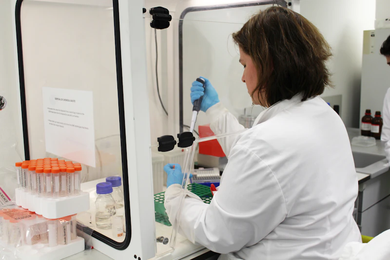 a researcher working with a sample in the lab