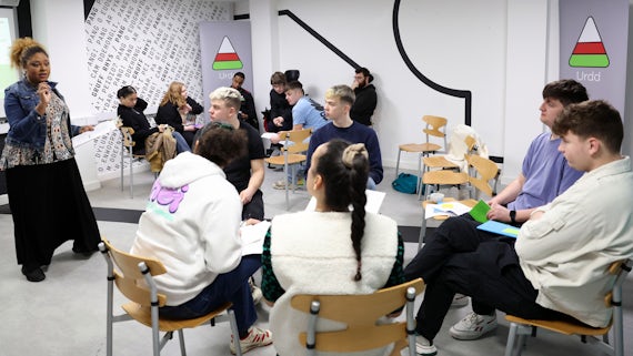 Wide shot of students in discussion group