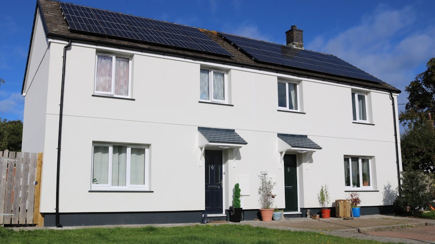 Semi-detached social housing retrofitted with solar panels, insulation, battery storage, ventilation and an air source heat pump.