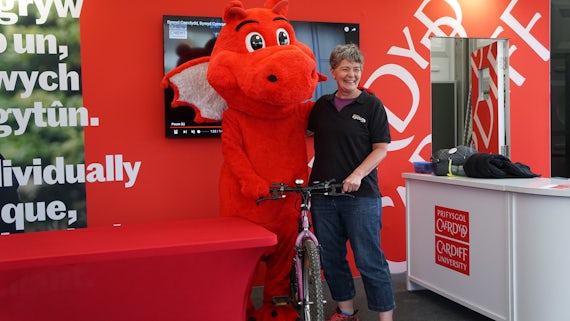 Our big, red, and cuddly ambassador, Dylan the Dragon visiting our Eisteddfod stall 