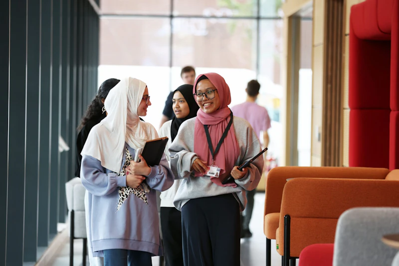 Two students walking in Abacws