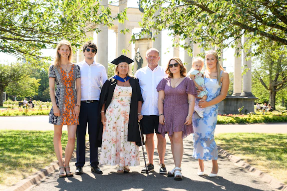 A group of people lined up for a family photo. 