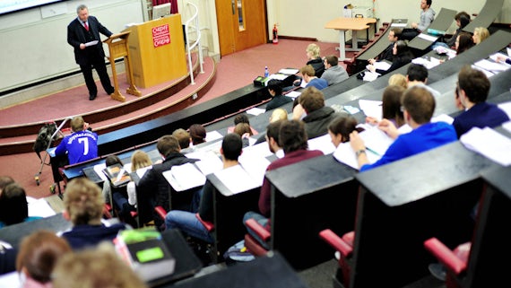 Man standing in front of a lecture theatre