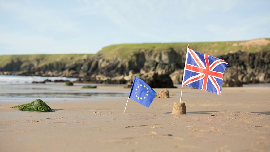 EU and UK flags on beach