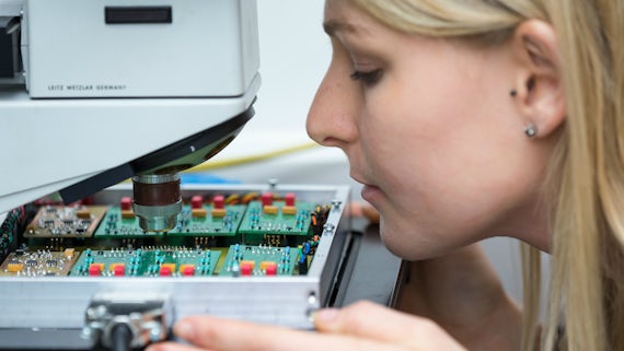 Researcher looking at compound semiconductor
