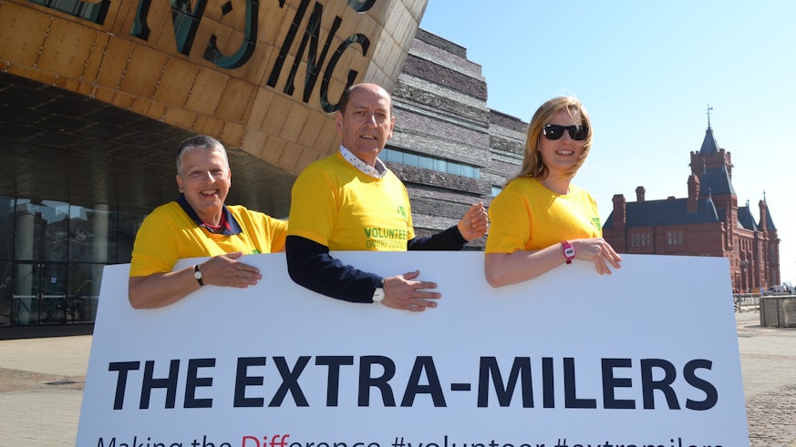 Runners holding sign saying 'The Extra Milers'