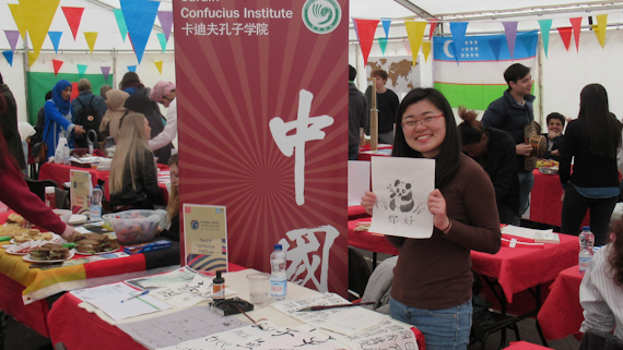 A Confucius Insitute tutor demonstrating traditional Chinese painting and calligraphy