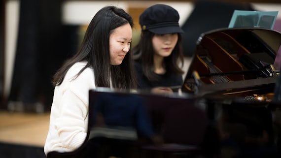 Two international students at piano