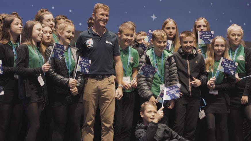 Pupils prepare to have their picture taken with UK astronaut Tim Peake.