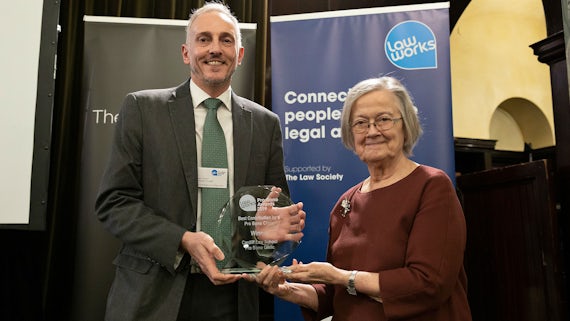 Professor Jason Tucker collects the Best Contribution by a Pro Bono clinic award from Baroness Hale